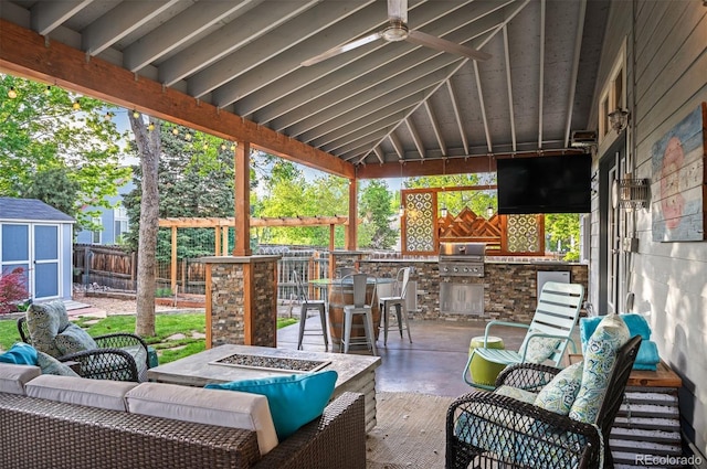 6480 Moss Cir, Arvada, CO 80007 - fenced backyard with an outdoor living space with a fire pit, exterior kitchen, a storage shed, and ceiling fan