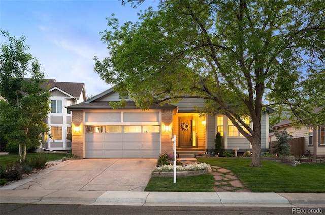 6480 Moss Cir, Arvada, CO 80007 - view of front facade with concrete driveway, an attached garage, brick siding, and a front lawn