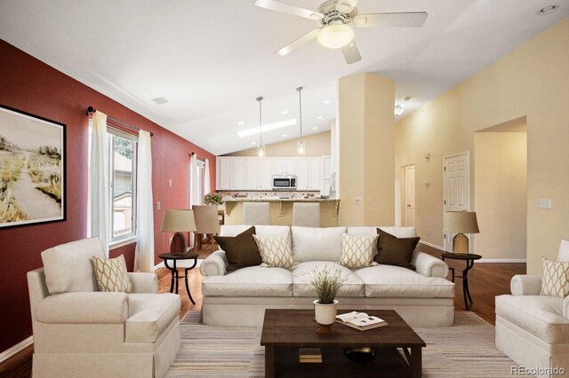 6480 Moss Cir, Arvada, CO 80007 - living area with lofted ceiling, light wood finished floors, a ceiling fan, and recessed lighting