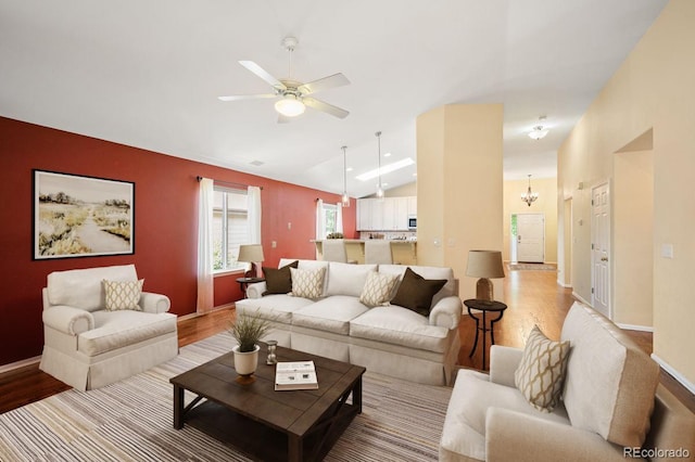 6480 Moss Cir, Arvada, CO 80007 - living room featuring light wood-style floors, vaulted ceiling, and ceiling fan