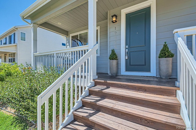 view of exterior entry featuring a porch