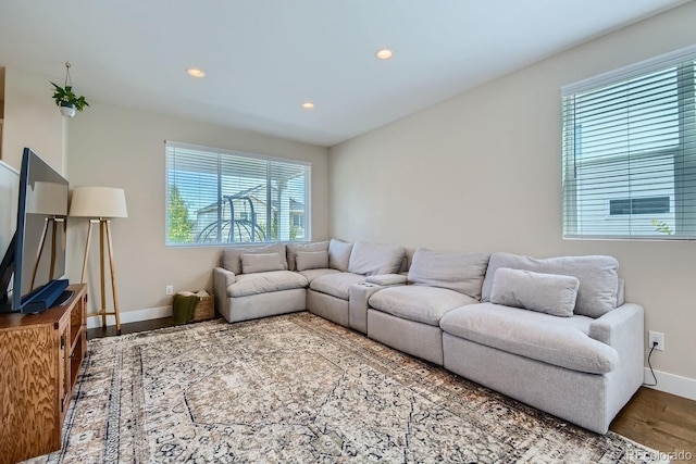 living area featuring recessed lighting, wood finished floors, and baseboards