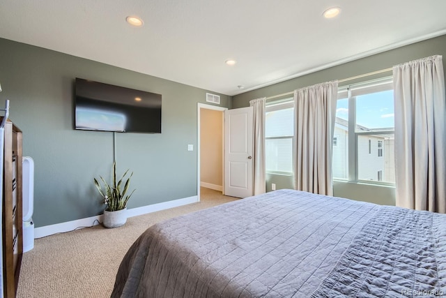 bedroom with recessed lighting, visible vents, light carpet, and baseboards