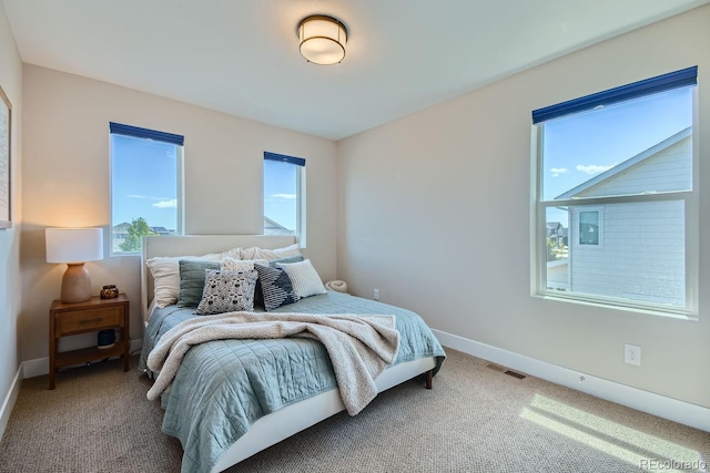 carpeted bedroom with baseboards and visible vents