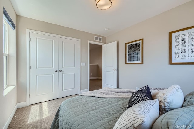 bedroom featuring a closet, visible vents, and baseboards