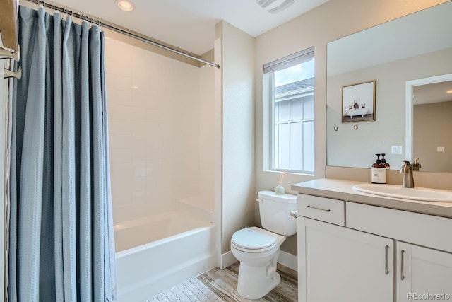 full bathroom featuring toilet, wood finished floors, visible vents, vanity, and shower / bathtub combination with curtain