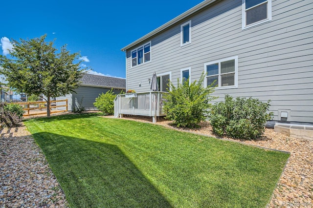 view of yard with fence and a wooden deck