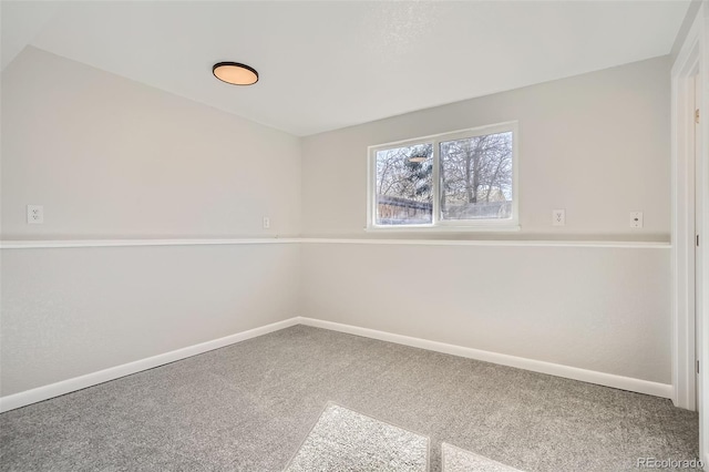 unfurnished room with carpet and baseboards