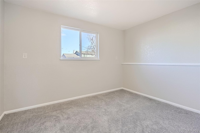 empty room with baseboards and carpet flooring