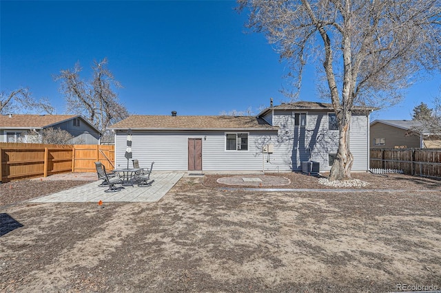 back of house featuring a fenced backyard, a patio, and central air condition unit