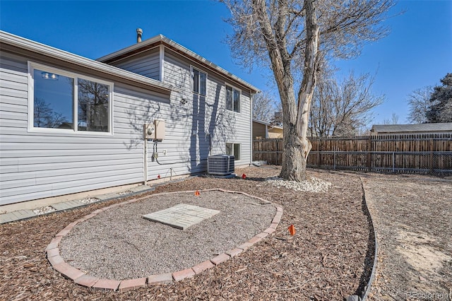 view of yard featuring cooling unit and fence