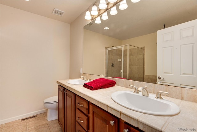 bathroom featuring tile patterned floors, vanity, toilet, and an enclosed shower