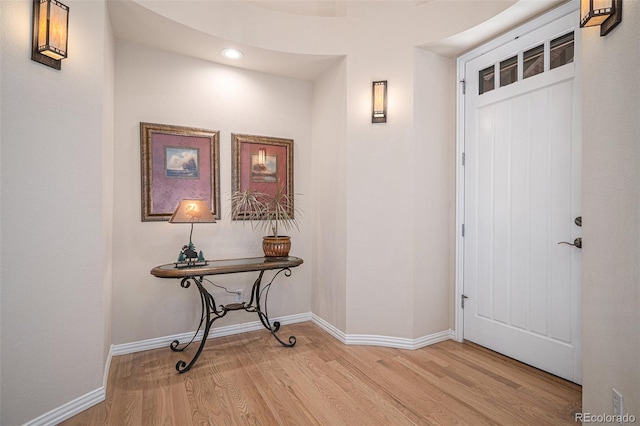 entryway with recessed lighting, light wood-style flooring, and baseboards