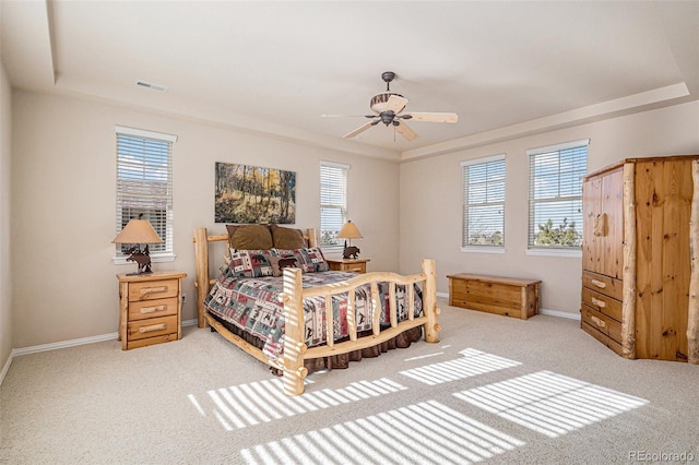 bedroom with carpet, baseboards, and a tray ceiling