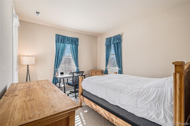 carpeted bedroom with visible vents