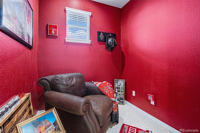 living area with beverage cooler, carpet flooring, a textured wall, and baseboards