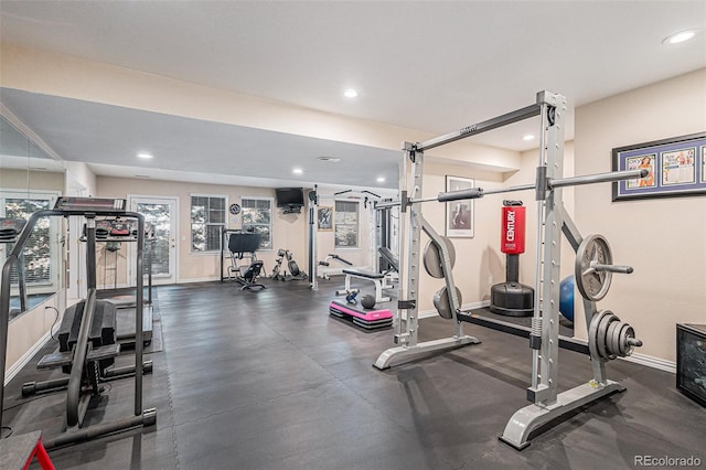 exercise room with baseboards and recessed lighting