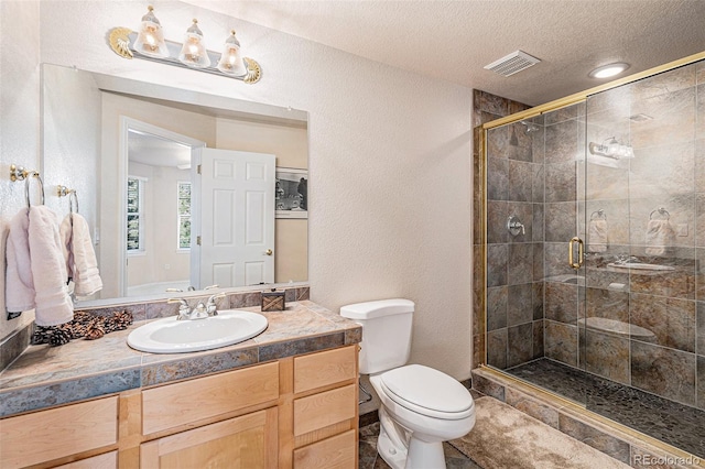 bathroom with toilet, a stall shower, visible vents, and a textured ceiling