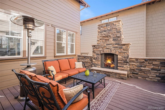 wooden deck with an outdoor living space with a fireplace