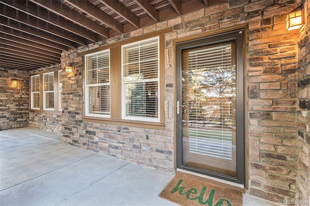 property entrance with stone siding