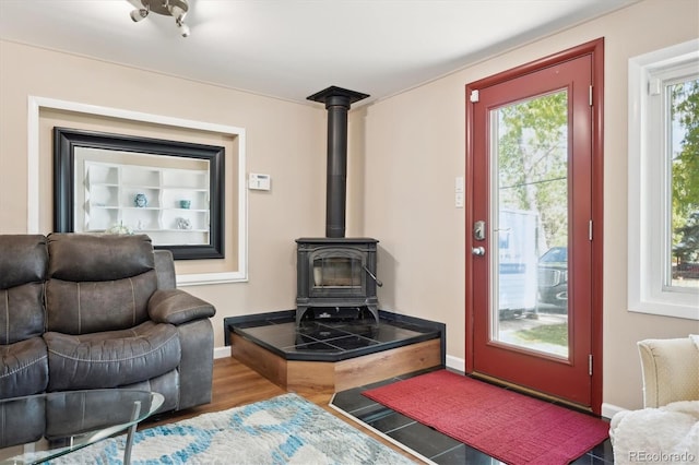 living room featuring hardwood / wood-style floors and a wood stove