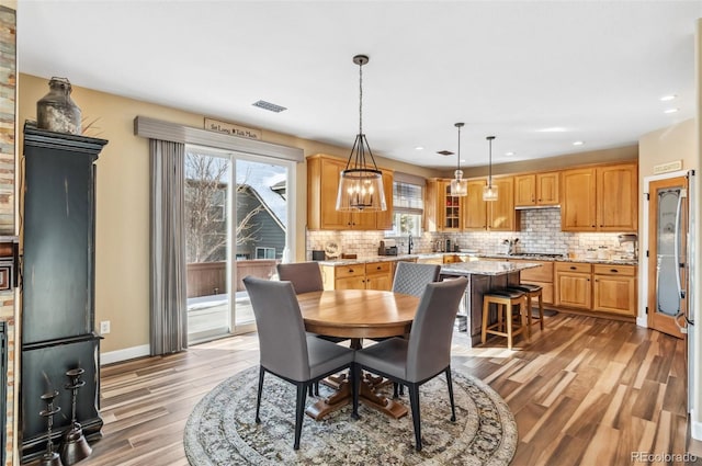 dining space with light hardwood / wood-style floors