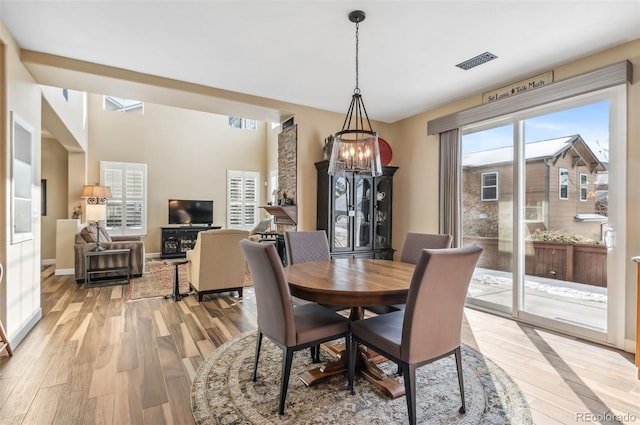 dining space featuring a notable chandelier and light wood-type flooring