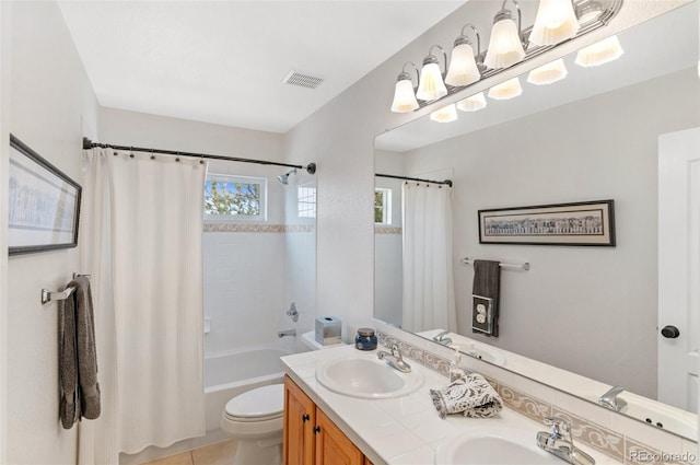 full bathroom with shower / bathtub combination with curtain, vanity, tile patterned floors, and toilet