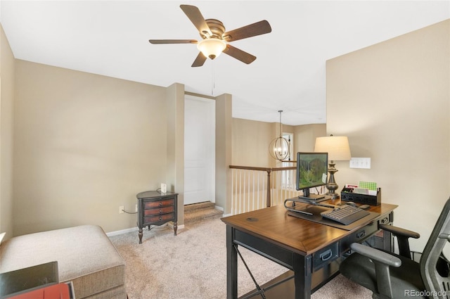 carpeted office with ceiling fan with notable chandelier