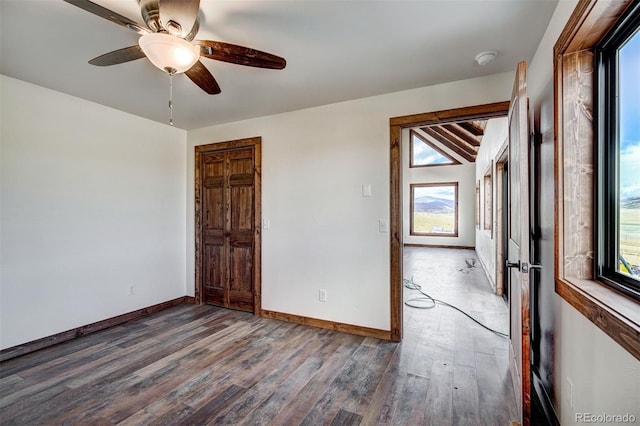 spare room with ceiling fan, baseboards, and wood finished floors