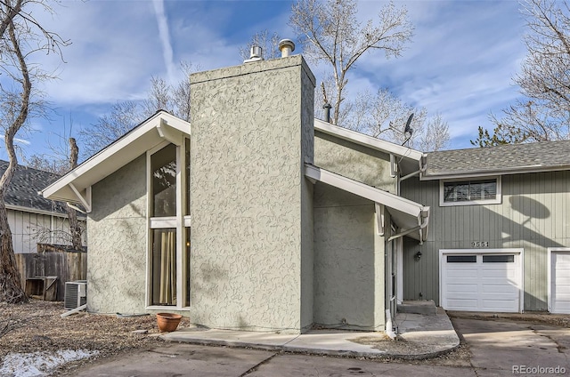 exterior space featuring a garage and central AC unit