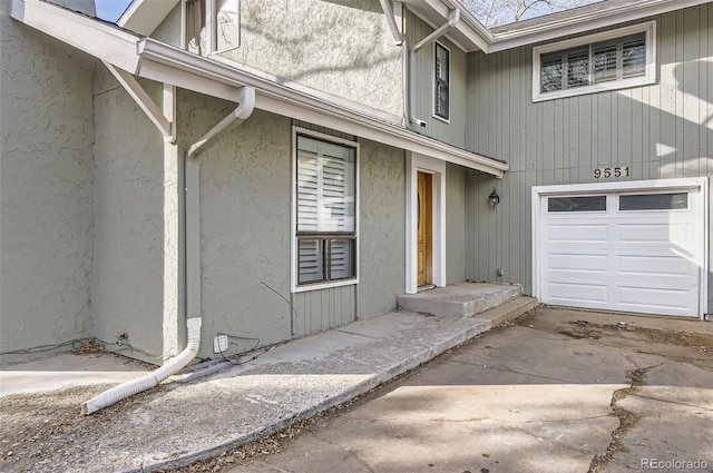 view of exterior entry with a garage