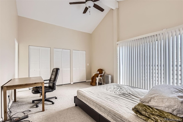 bedroom featuring radiator, high vaulted ceiling, two closets, light colored carpet, and beamed ceiling