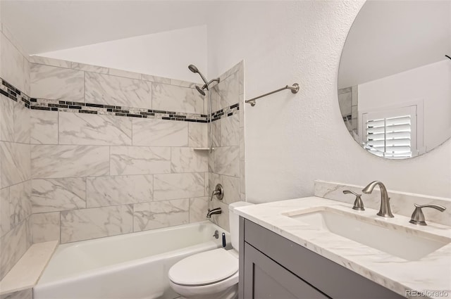 full bathroom with vanity, toilet, and tiled shower / bath