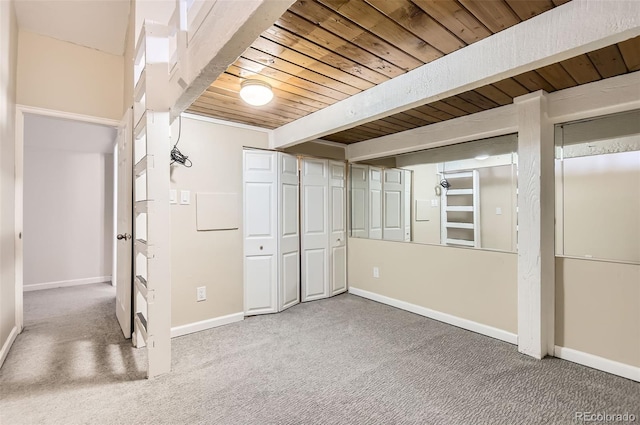 basement with wood ceiling and carpet