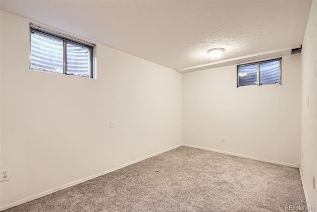 basement featuring carpet floors and a textured ceiling