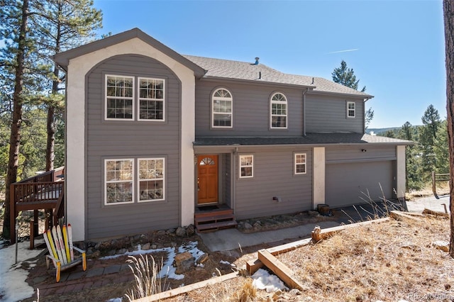 view of front of house with a shingled roof and entry steps