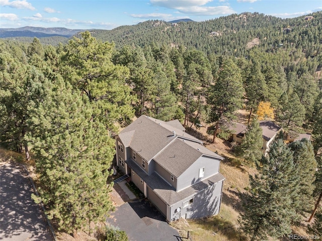 birds eye view of property with a mountain view and a view of trees