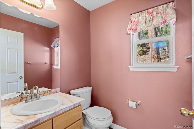 6904 Sprucedale Park Way, Evergreen, CO 80439 - bathroom featuring toilet, vanity, and baseboards