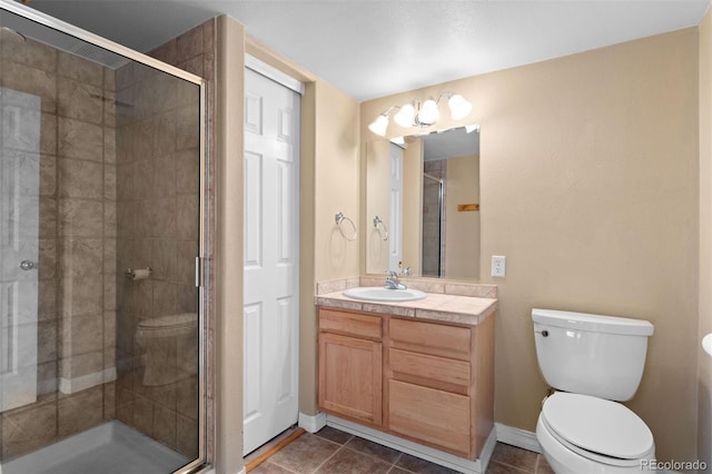 6904 Sprucedale Park Way, Evergreen, CO 80439 - full bath with toilet, a shower stall, vanity, tile patterned floors, and baseboards