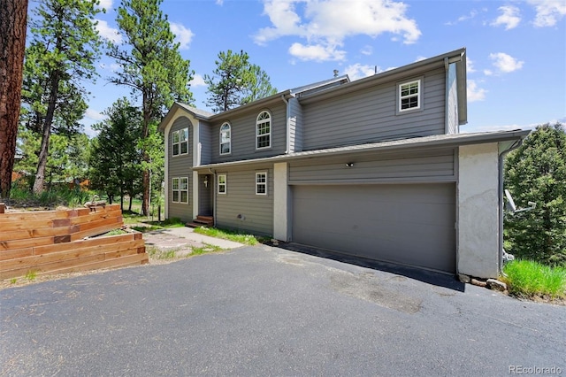 6904 Sprucedale Park Way, Evergreen, CO 80439 - view of front of property featuring a garage and asphalt driveway
