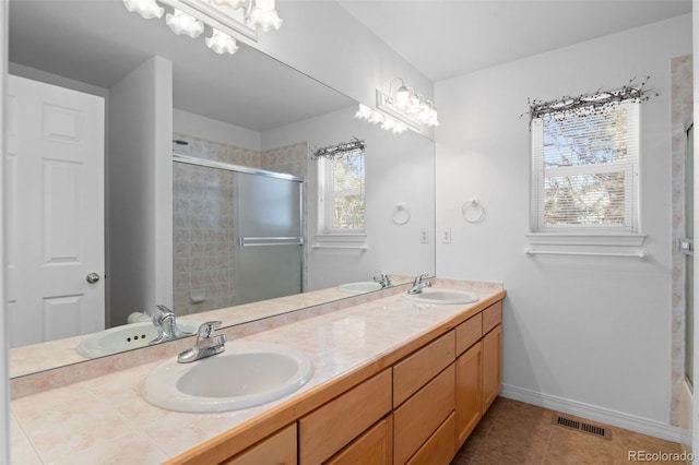 6904 Sprucedale Park Way, Evergreen, CO 80439 - bathroom with a tile shower, double vanity, tile patterned flooring, and baseboards