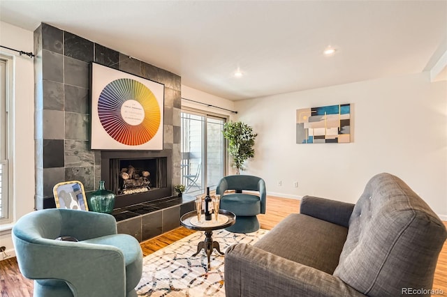 701 Harlan St Unit E59, Lakewood, CO 80214 - living room featuring baseboards, recessed lighting, wood finished floors, and a tile fireplace
