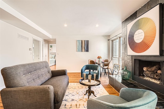 701 Harlan St Unit E59, Lakewood, CO 80214 - living area with visible vents, wood finished floors, baseboards, recessed lighting, and a large fireplace