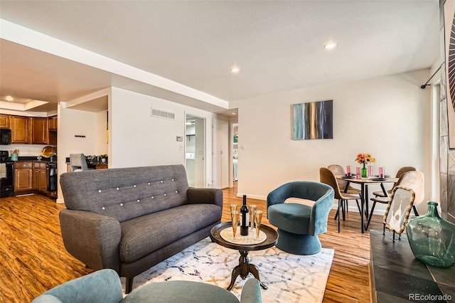 701 Harlan St Unit E59, Lakewood, CO 80214 - living room featuring recessed lighting, baseboards, visible vents, and wood finished floors