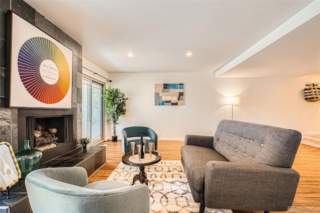 701 Harlan St Unit E59, Lakewood, CO 80214 - living room featuring baseboards, recessed lighting, wood finished floors, and a tiled fireplace