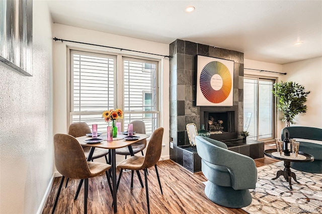 701 Harlan St Unit E59, Lakewood, CO 80214 - interior space featuring baseboards, recessed lighting, wood finished floors, and a tile fireplace
