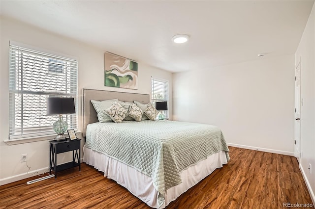 701 Harlan St Unit E59, Lakewood, CO 80214 - bedroom featuring baseboards, wood finished floors, and visible vents