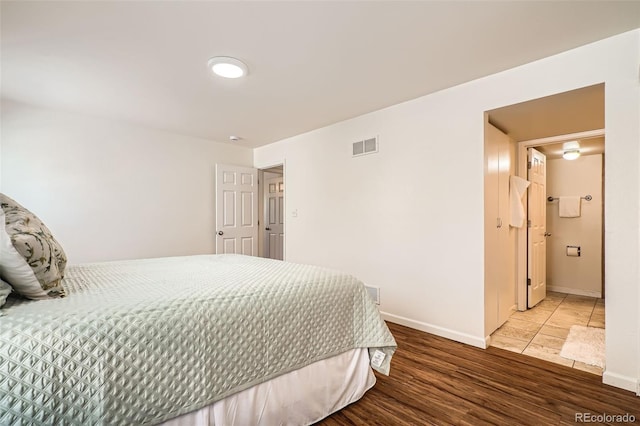 701 Harlan St Unit E59, Lakewood, CO 80214 - bedroom with visible vents, baseboards, and wood finished floors