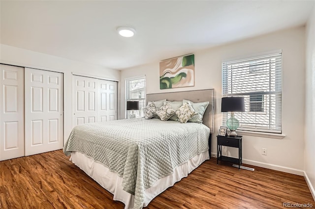 701 Harlan St Unit E59, Lakewood, CO 80214 - bedroom with baseboards, two closets, and wood finished floors
